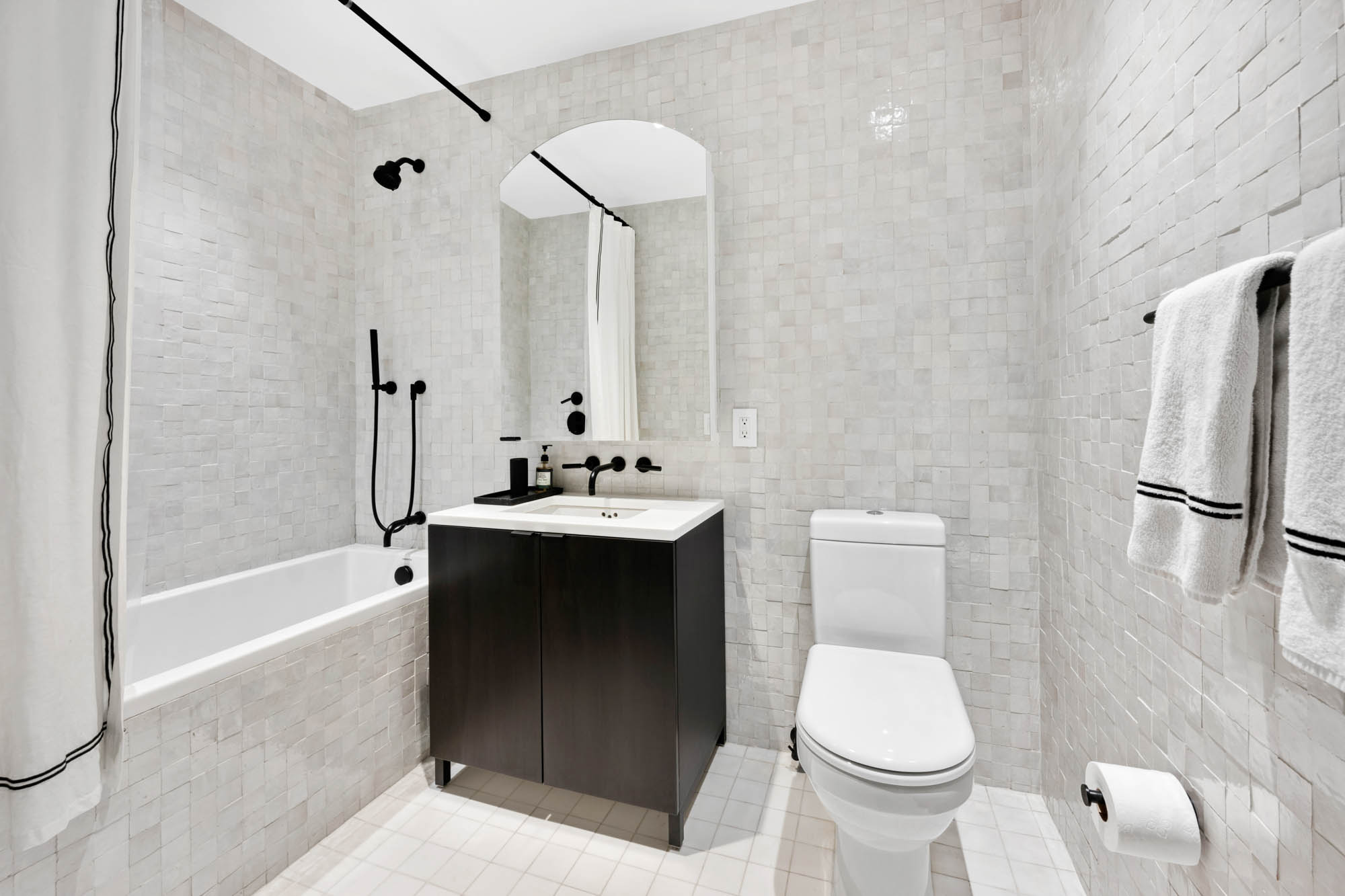 55 West 17th Street, Unit 701 Manhattan, NY 10011 - Photo 10 of 20 a bathroom with a sink toilet and shower