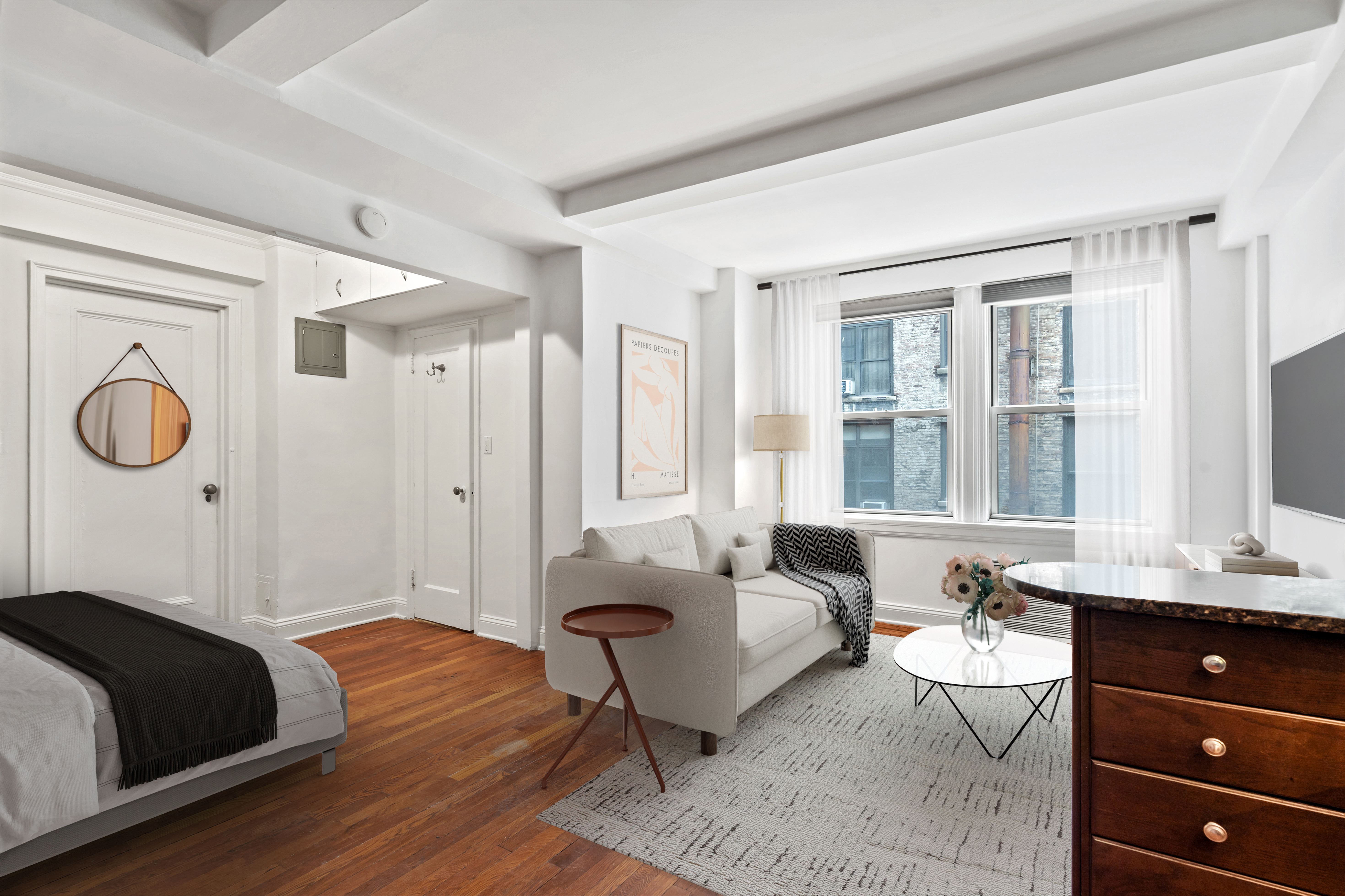 a bedroom with a bed and wooden floor