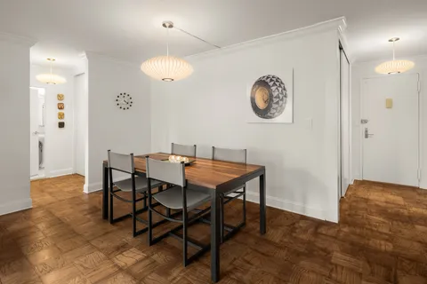 a dining room with a table and chairs