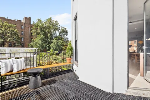 a view of balcony with wooden floor