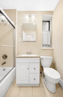 a bathroom with a sink a toilet and bathtub