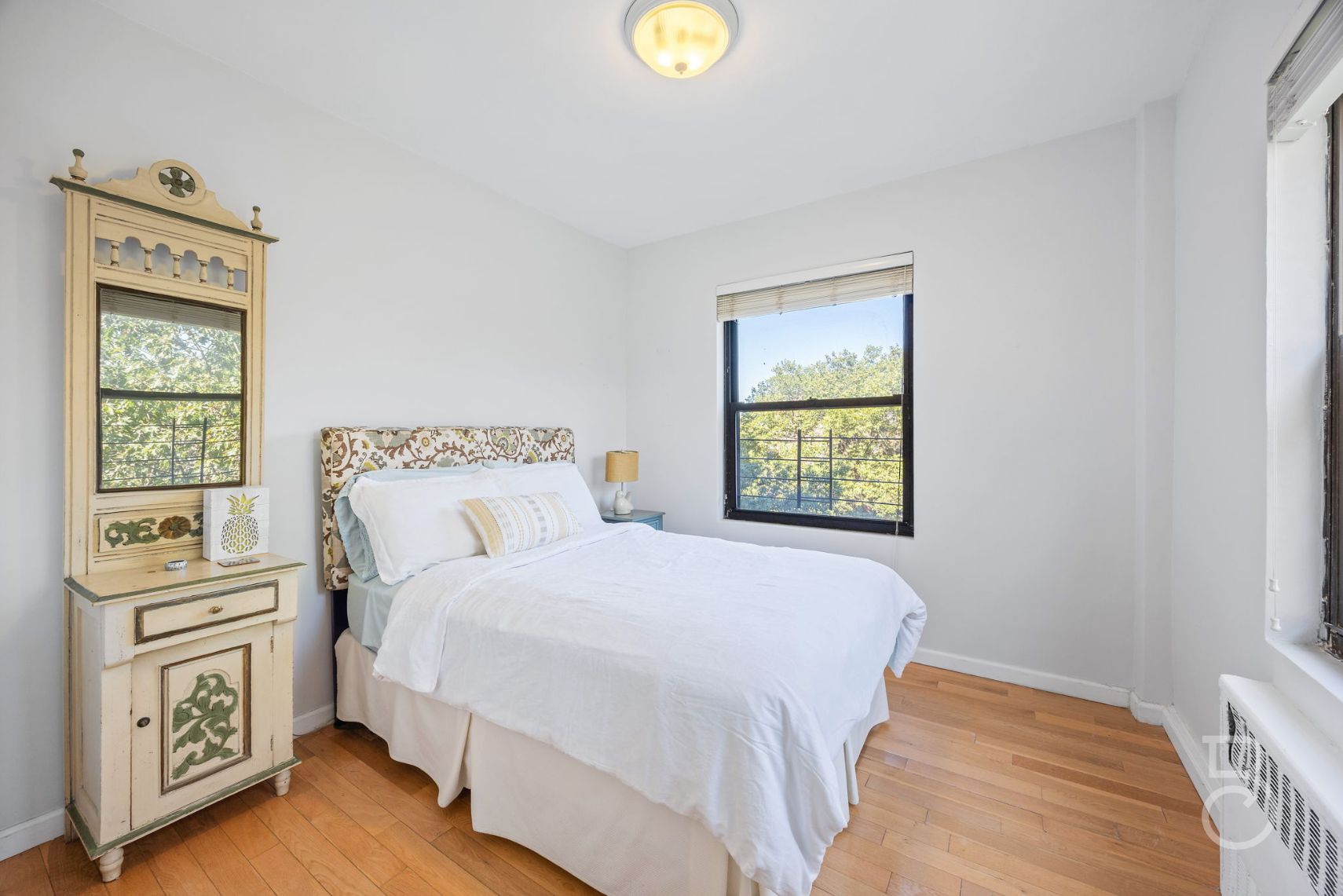 99-52 66th Road, Unit 5D Queens, NY 11374 - Photo 6 of 13 a bedroom with a bed and a window