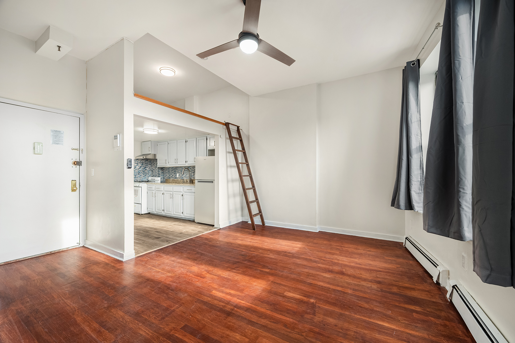 357 West 120th Street, Unit 3F Manhattan, NY 10027 - Photo 2 of 5 a view of empty room with wooden floor and fan