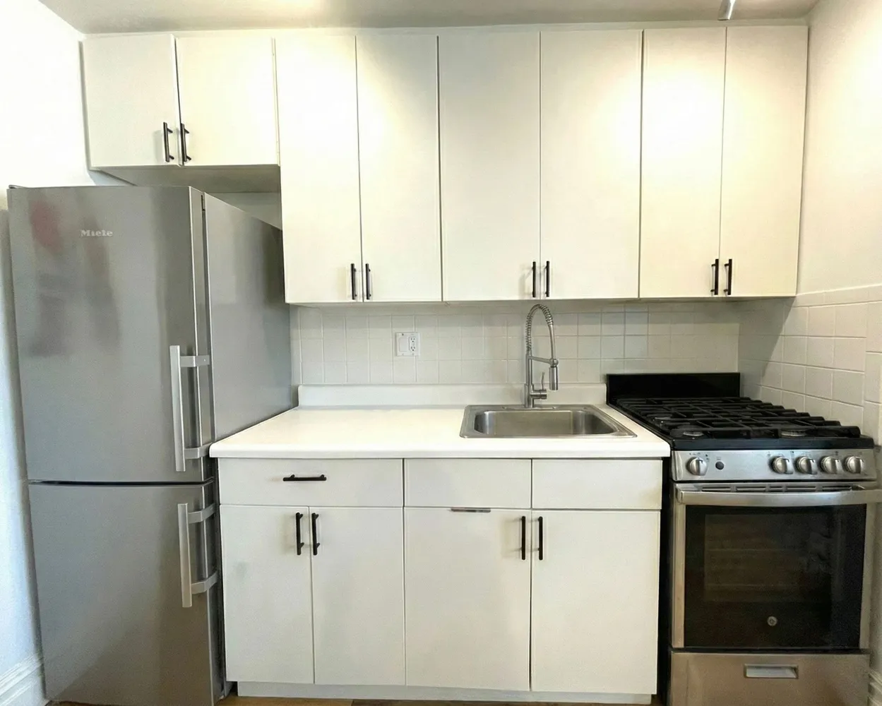 a kitchen with a white cabinets and white stove