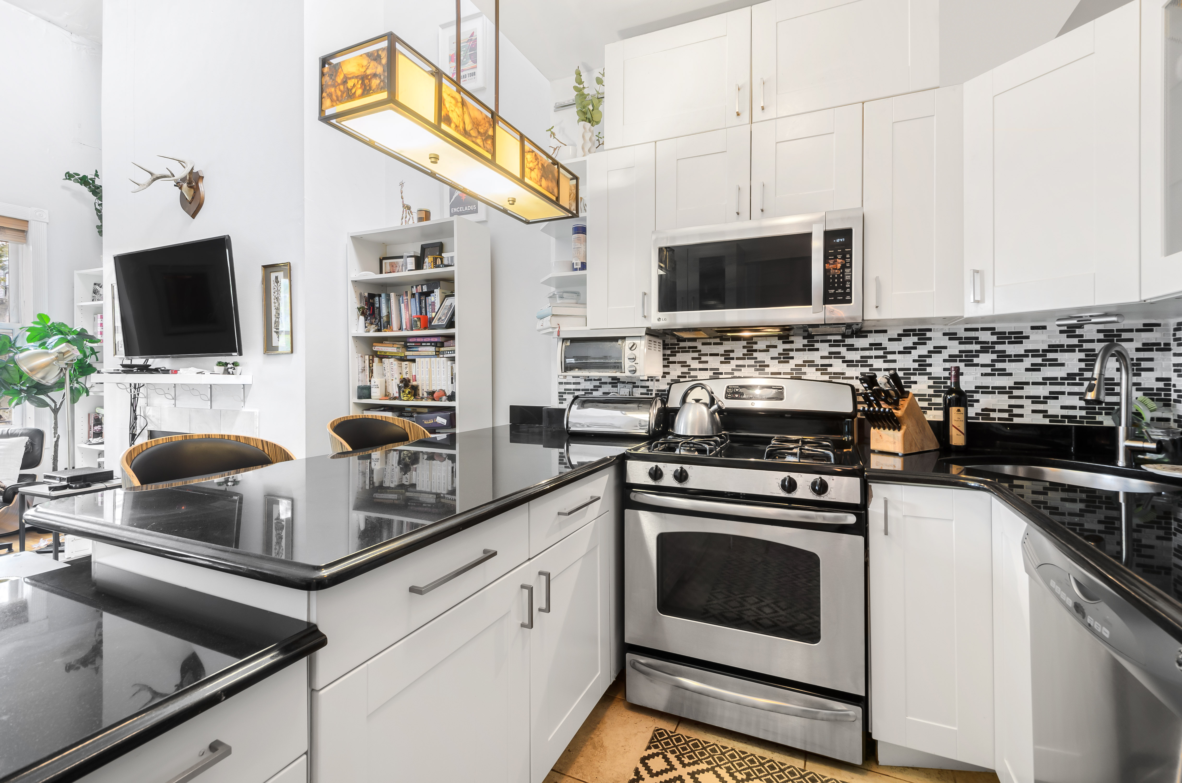 173 Greene Avenue, Unit 2 Brooklyn, NY 11238 - Photo 4 of 12 a kitchen with stainless steel appliances a stove a sink and a microwave