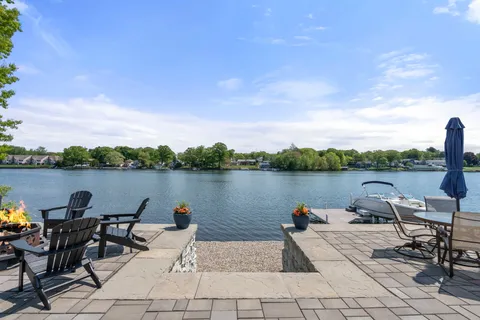 a lake view with tables and chairs