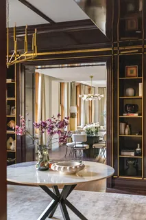a view of a dining room with furniture and chandelier
