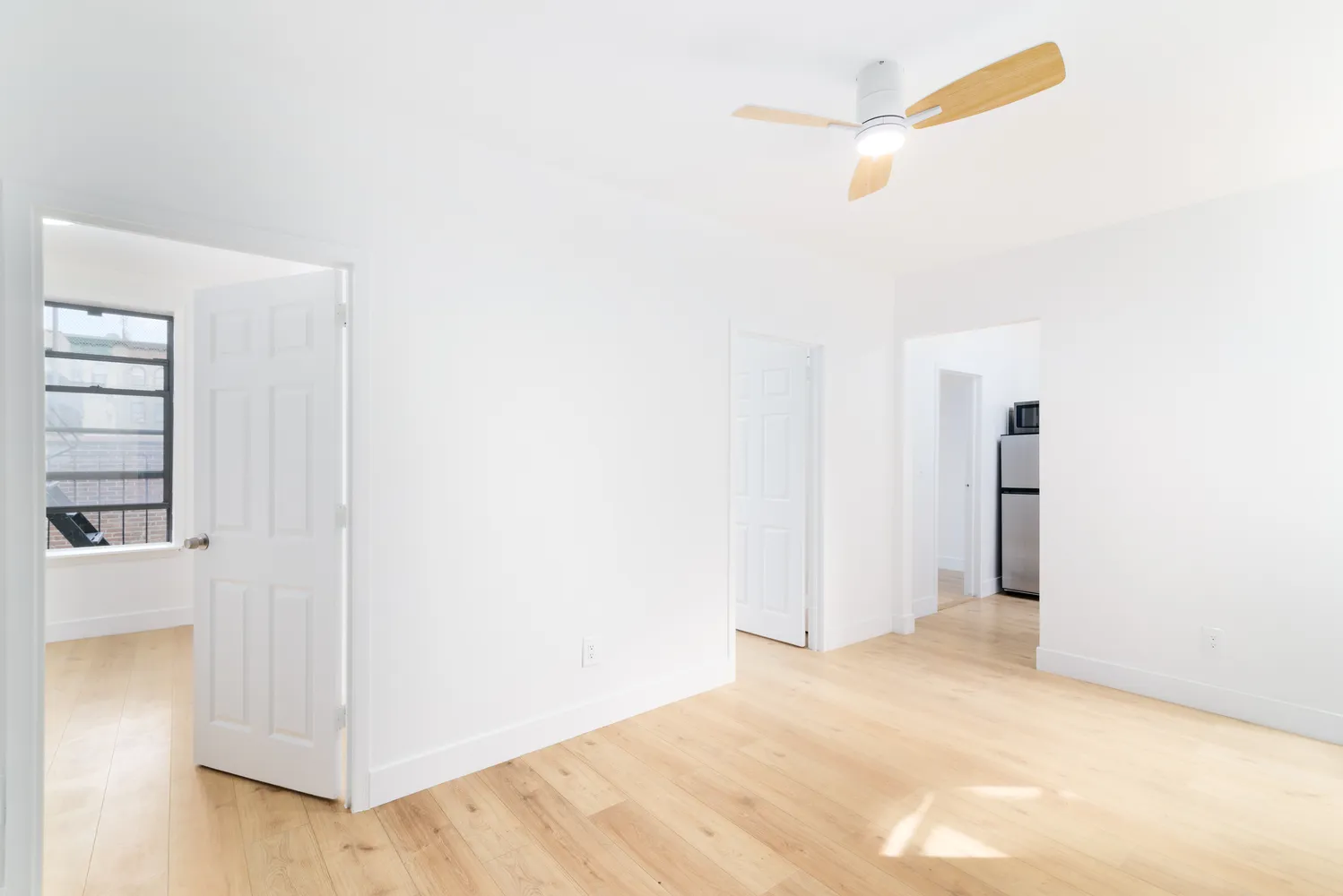 a view of empty room with wooden floor