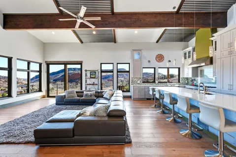 a view of a workspace with furniture and a window