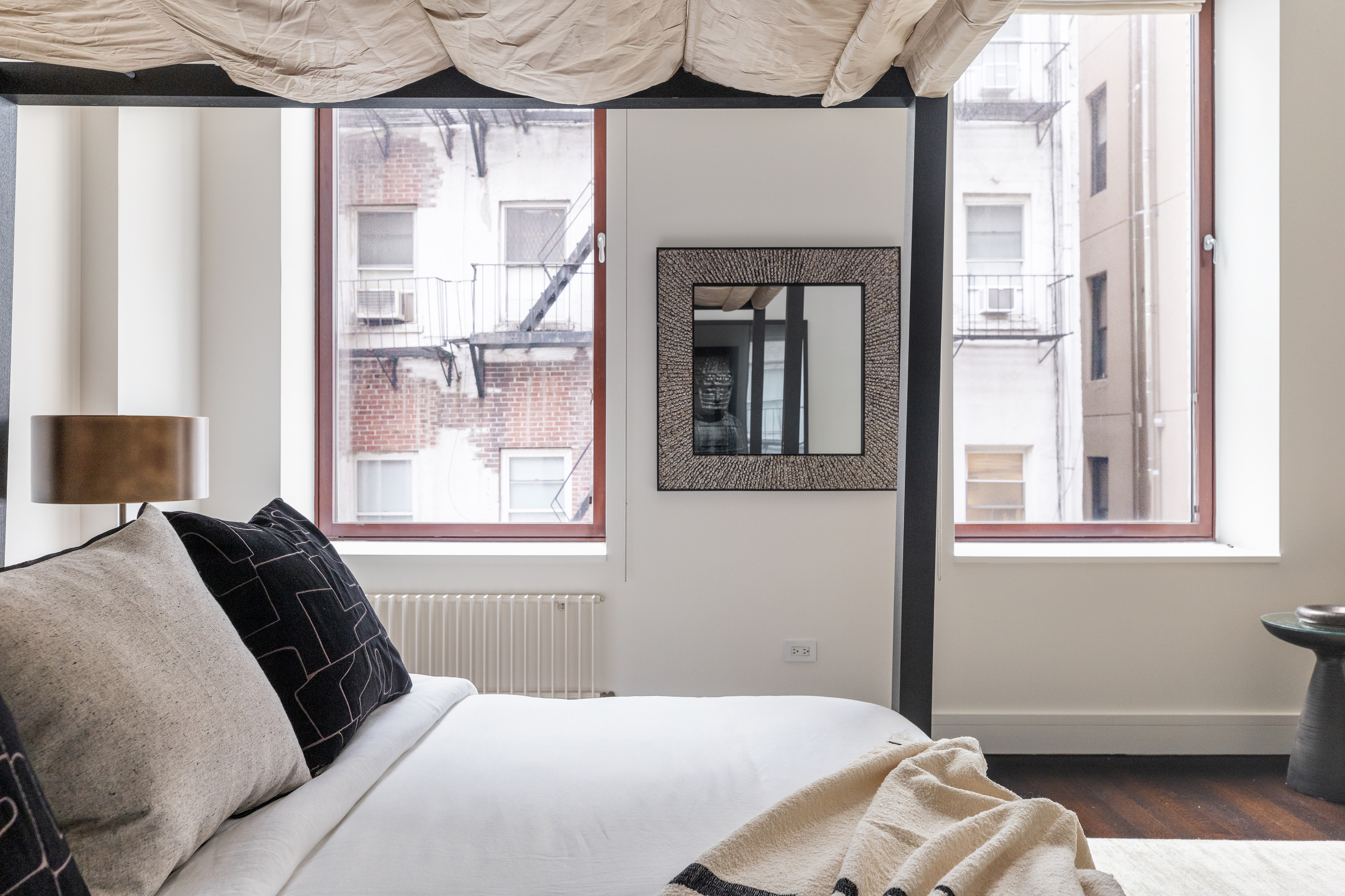 388 West Broadway, Unit 2 Manhattan, NY 10012 - Photo 13 of 27 a bedroom with a bed and a window