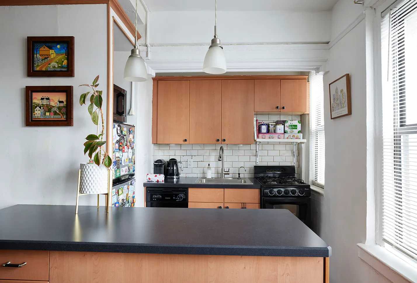 a kitchen with stainless steel appliances granite countertop a refrigerator a sink dishwasher a stove and white countertops with wooden floor