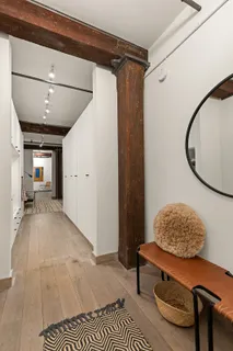 a living room with furniture and a mirror