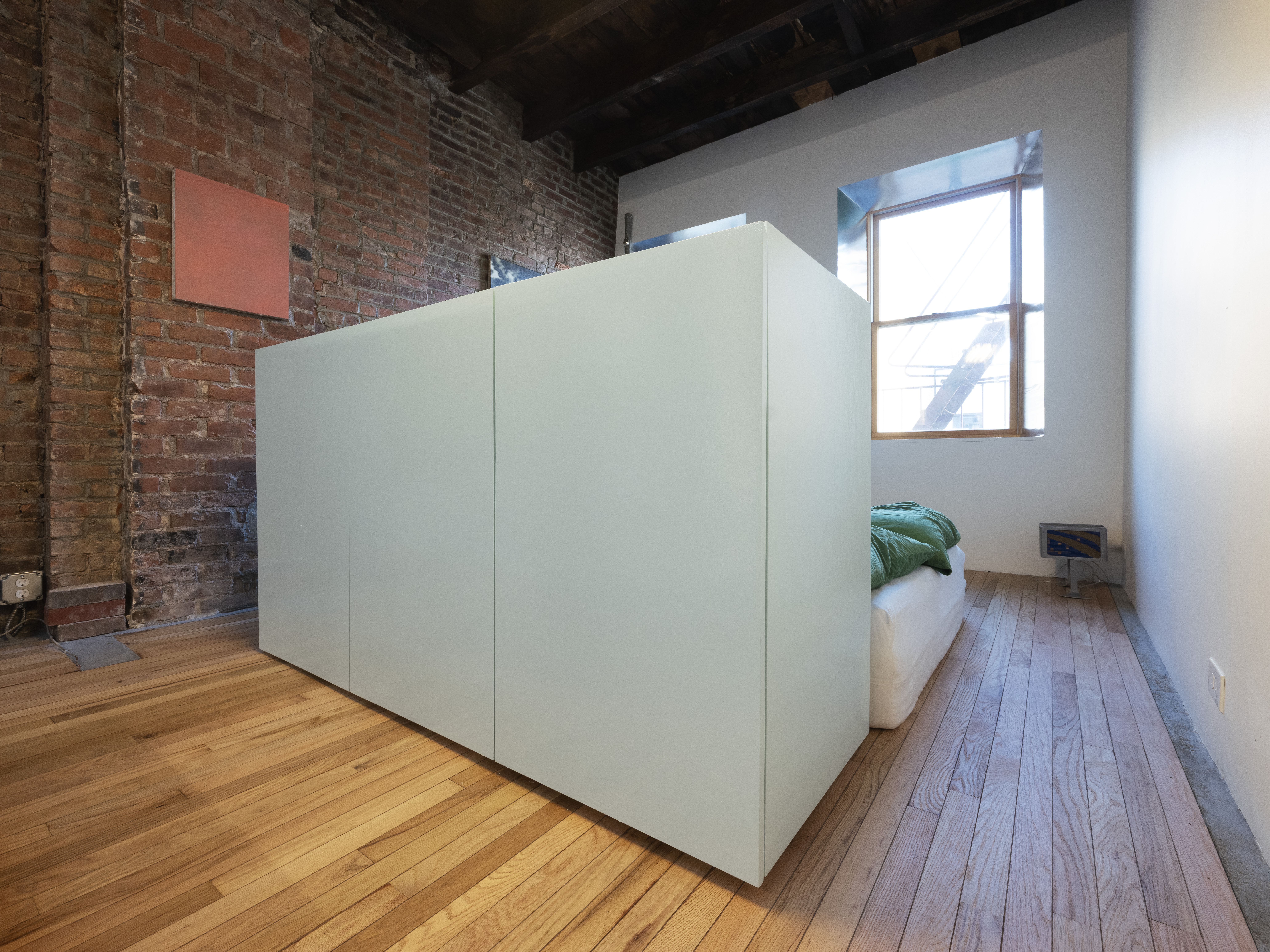 186 East 2nd Street, Unit 16 Manhattan, NY 10009 - Photo 15 of 17 a view of a hallway with wooden floor and a fireplace