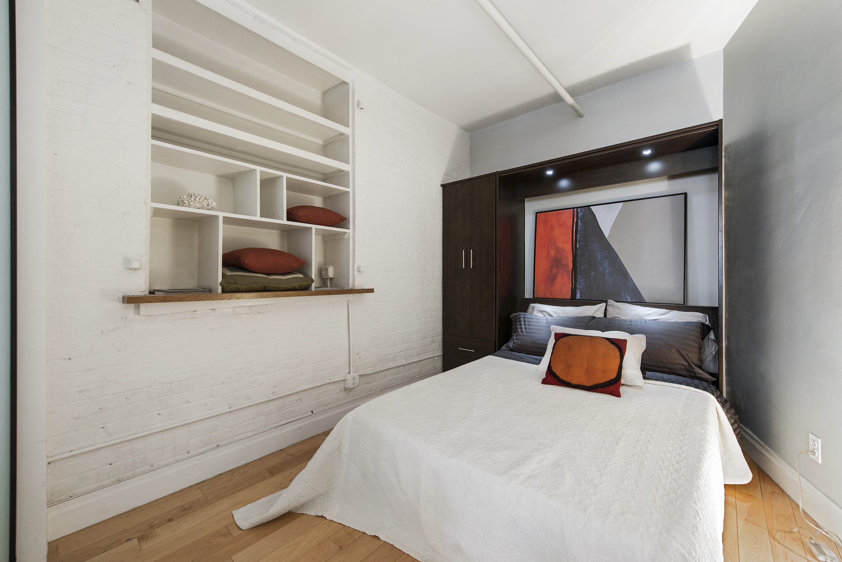 108 Wooster Street, Unit 5B Manhattan, NY 10012 - Photo 6 of 9 a bedroom with a bed and window