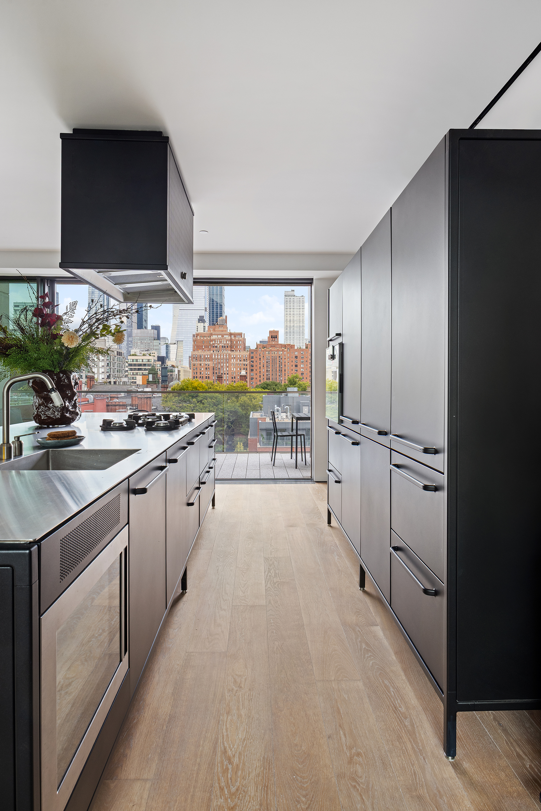 455 West 19th Street, Unit PH2 Manhattan, NY 10011 - Photo 8 of 26 a kitchen with stainless steel appliances a sink dishwasher stove refrigerator and microwave