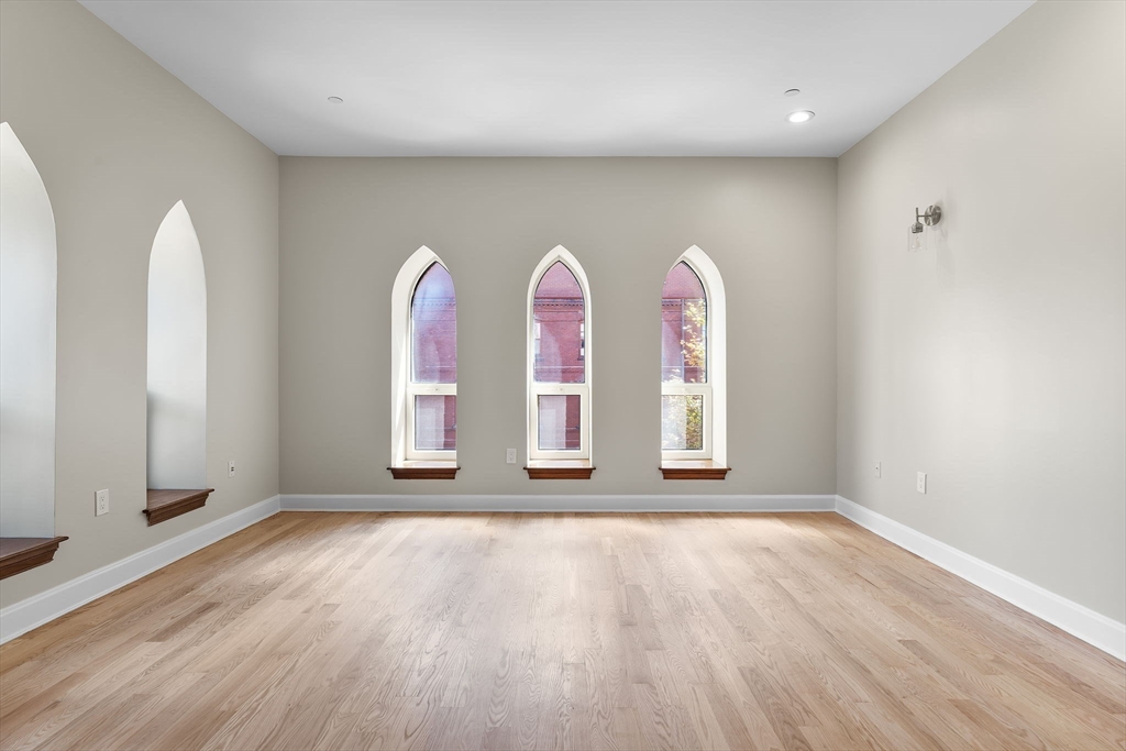 2 Clarendon Street, Unit 401 Boston, MA 02116 - Photo 5 of 13 wooden floor in an empty room with window