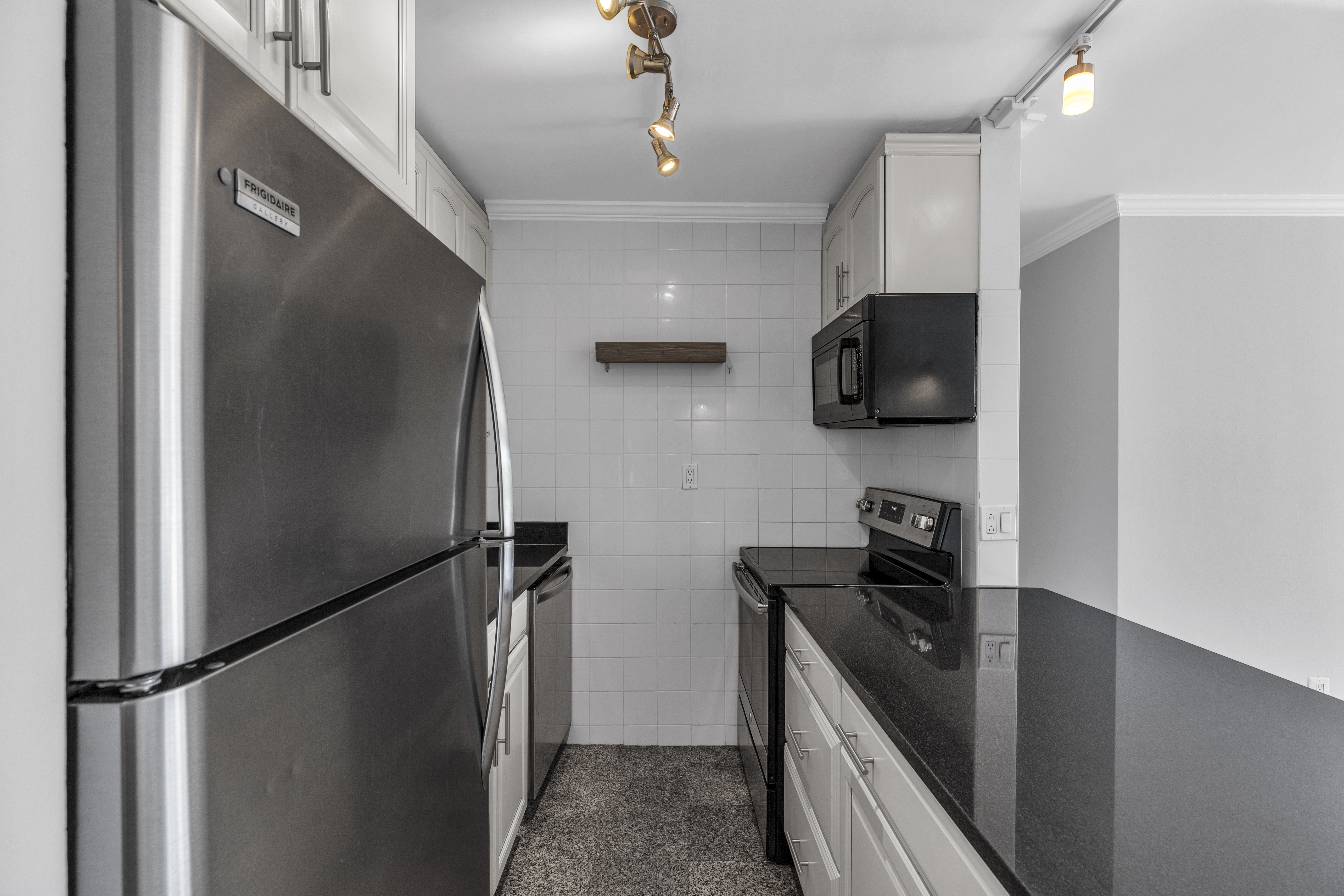 25-40 Shore Boulevard, Unit 2F Queens, NY 11102 - Photo 8 of 31 a kitchen with stainless steel appliances granite countertop a refrigerator a stove and a sink