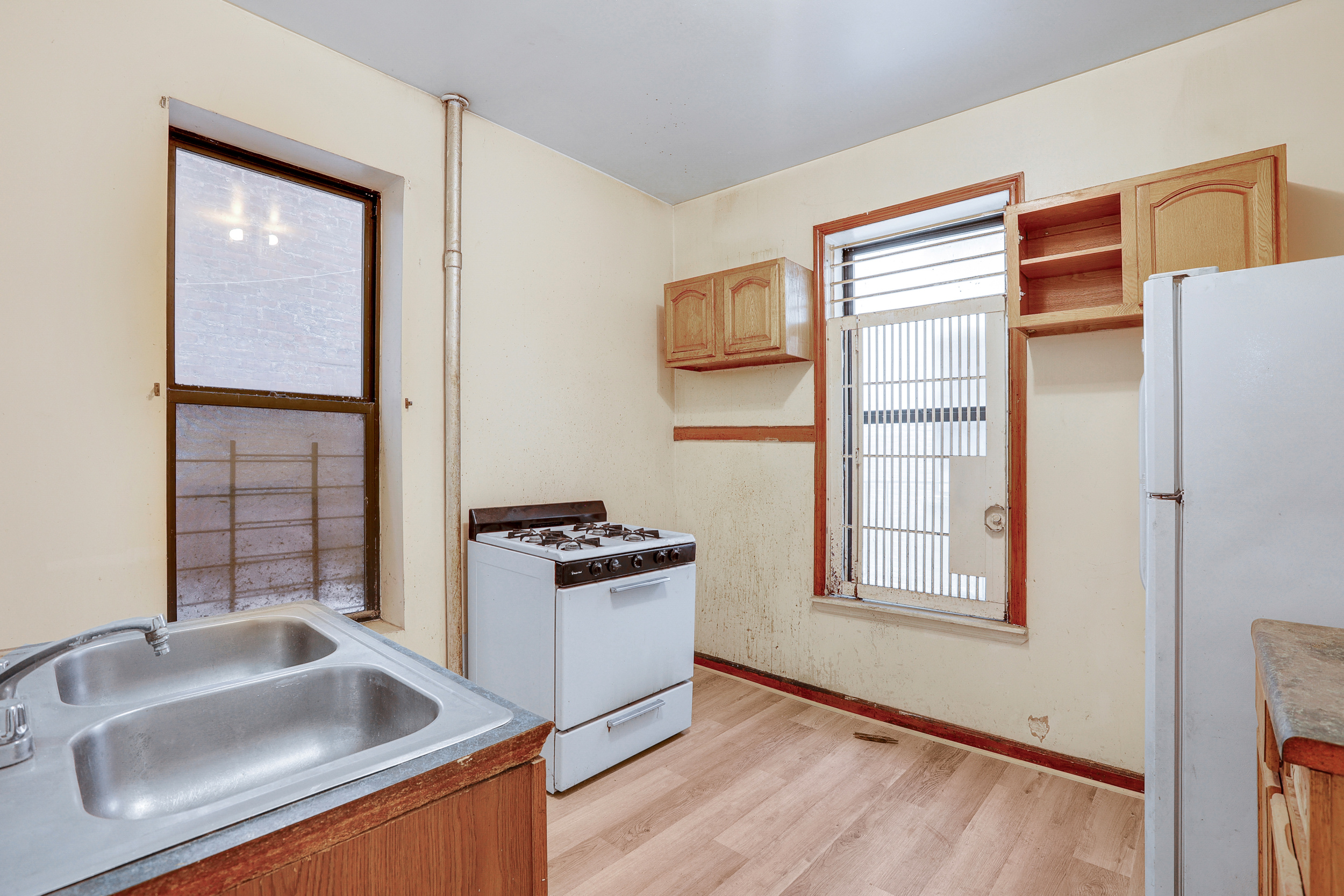282 Manhattan Avenue, Unit 3N Manhattan, NY 10026 - Photo 12 of 17 a kitchen with sink refrigerator and window