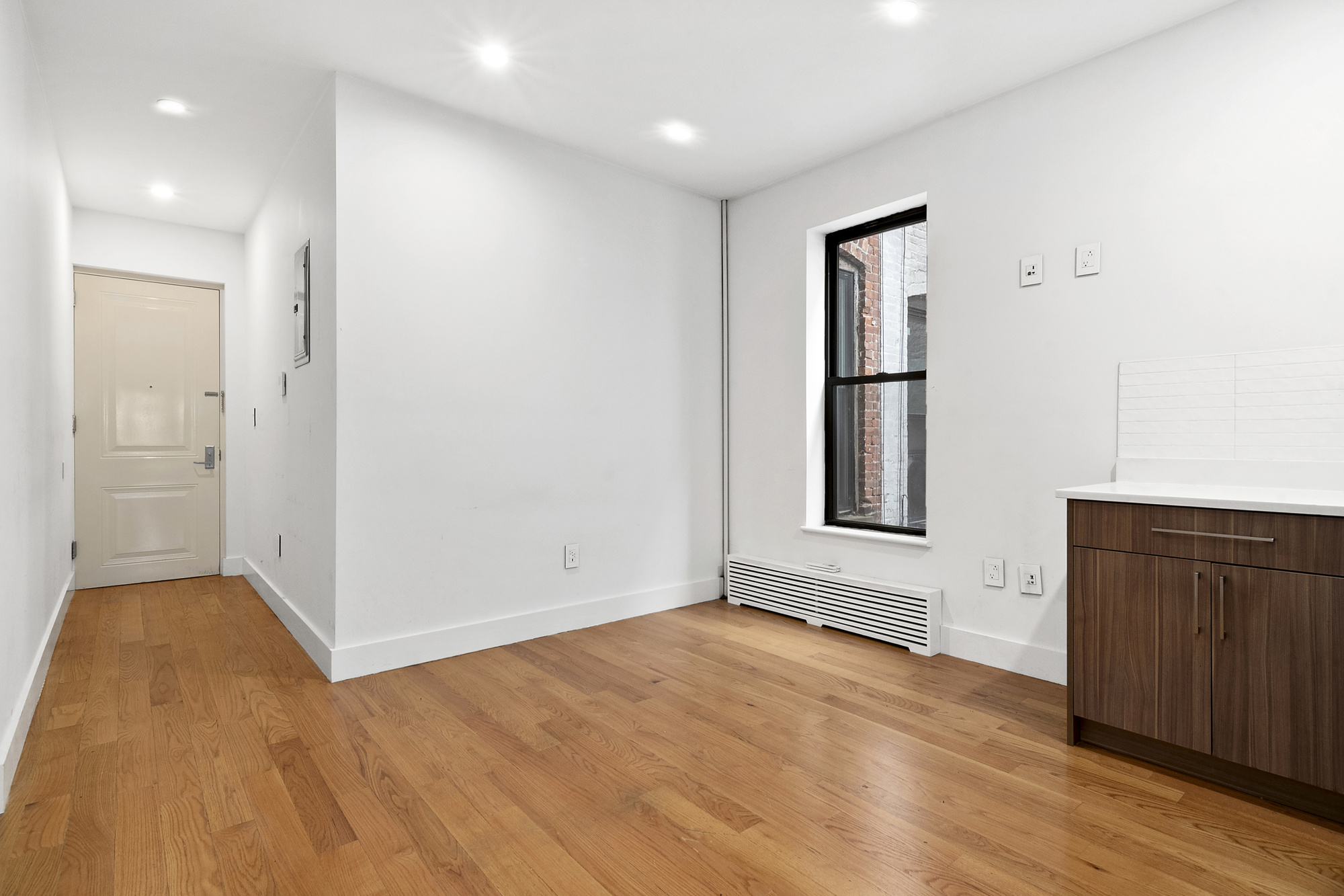 211 8th Avenue, Unit 3B Brooklyn, NY 11215 - Photo 7 of 13 a view of an empty room with wooden floor