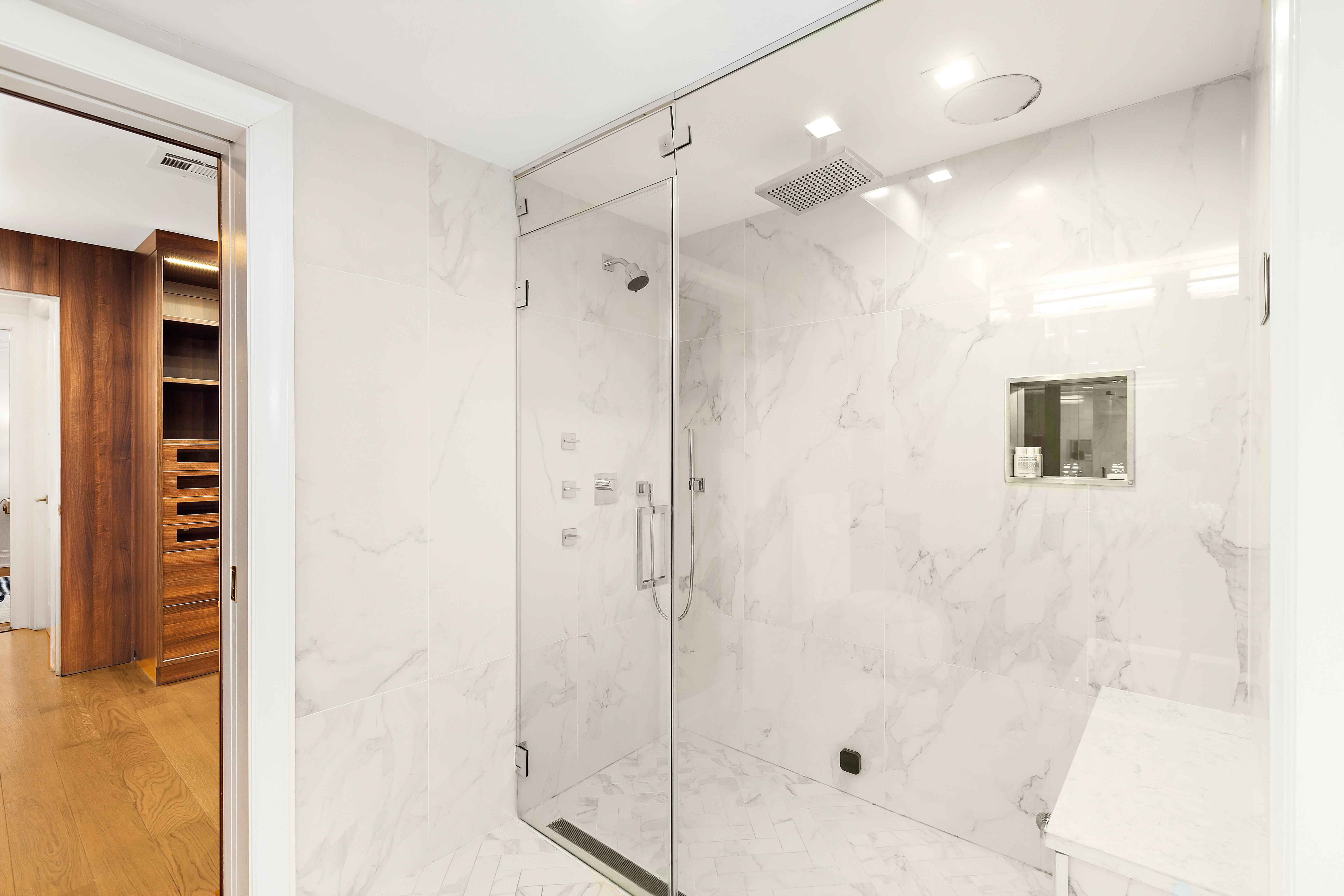134 East 36th Street Manhattan, NY 10016 - Photo 13 of 28 a bathroom with a shower and a glass door