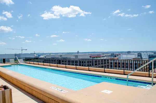 a view of a swimming pool with outdoor seating and yard