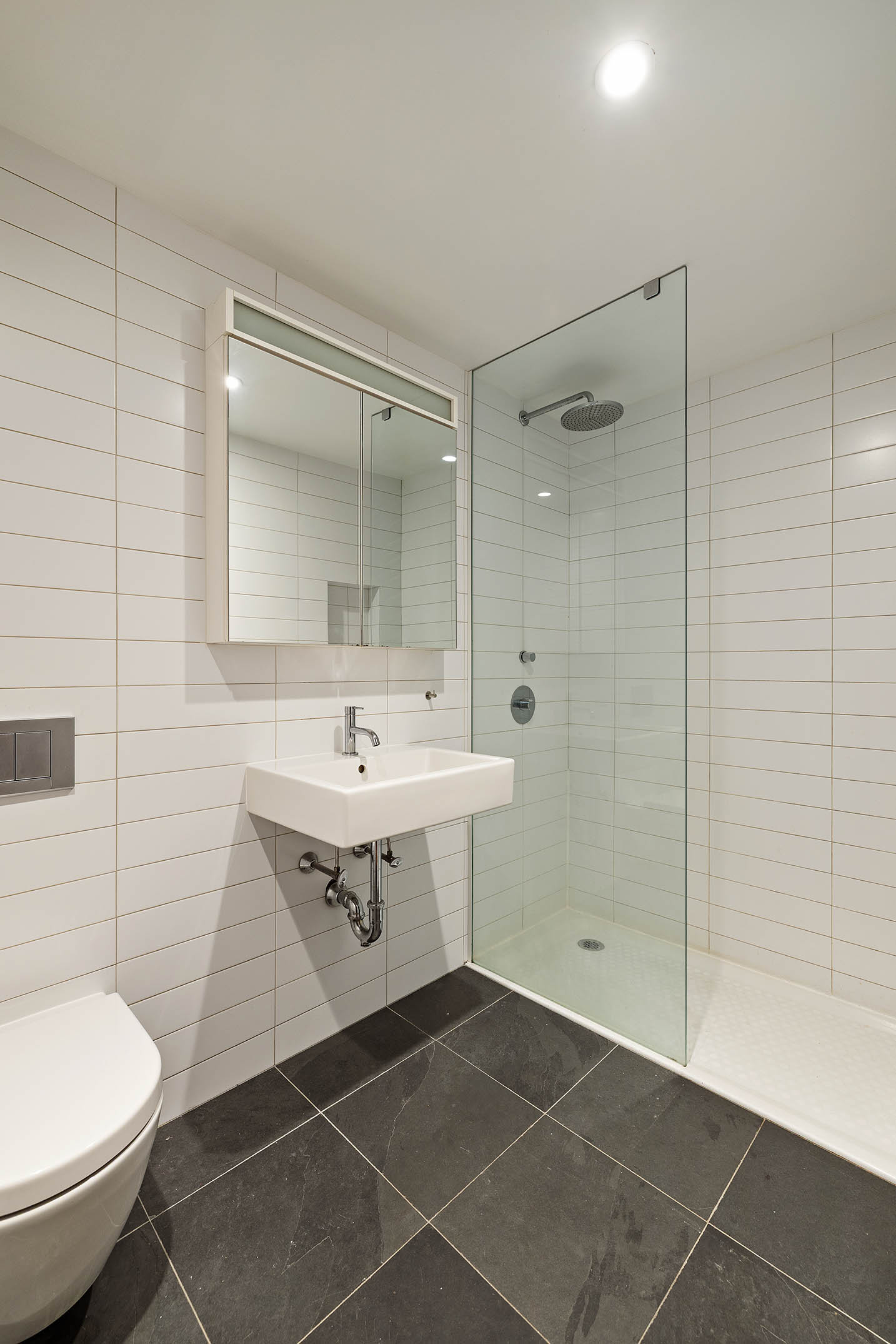 75 Sullivan Street, Unit 5S Manhattan, NY 10012 - Photo 7 of 12 a bathroom with a sink toilet and shower