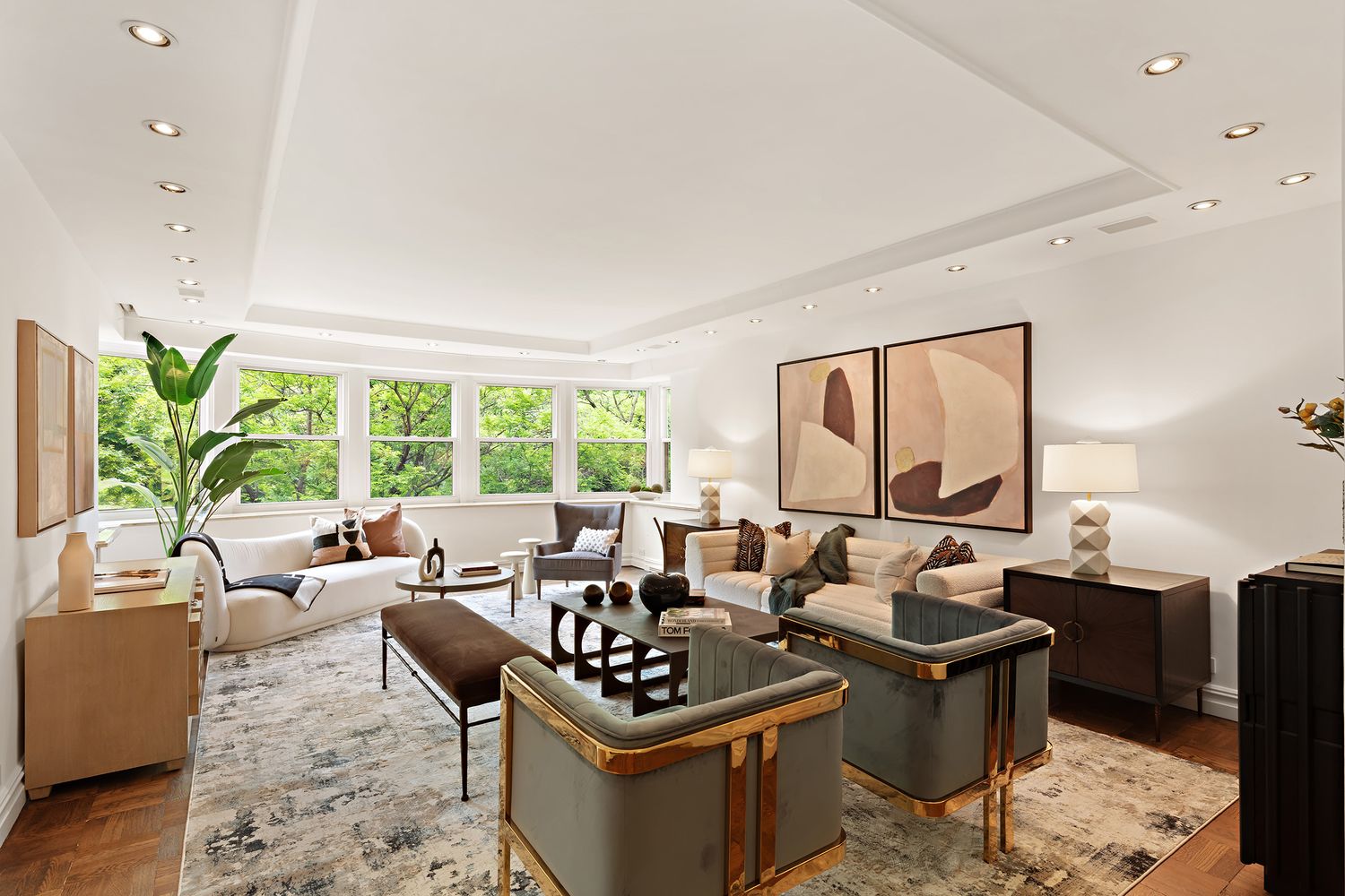 900 5th Avenue, Unit 4B Manhattan, NY 10021 - Photo 1 of 14 a living room with furniture and a large window