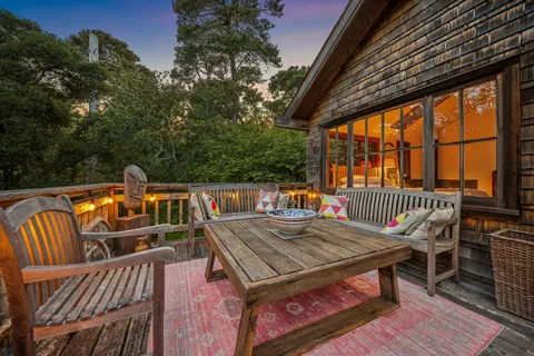 a view of a patio with table and chairs potted plants with wooden floor and seating space