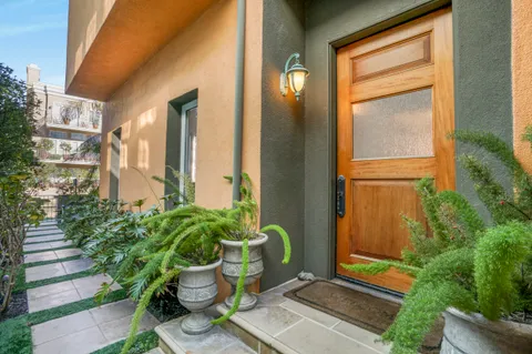 a view of a balcony with chair and potted plants