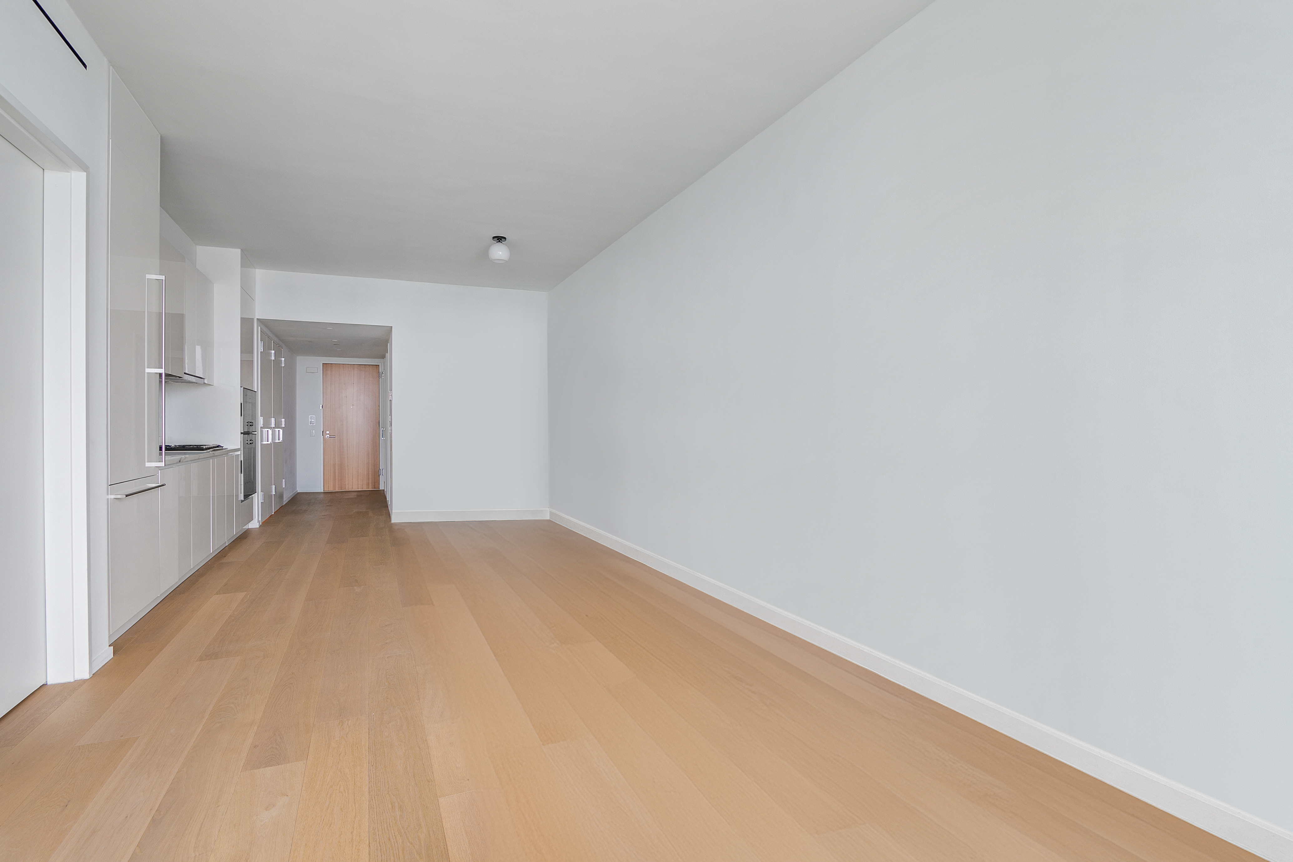 695 1st Avenue, Unit 31C Manhattan, NY 10016 - Photo 10 of 27 a view of empty room with wooden floor