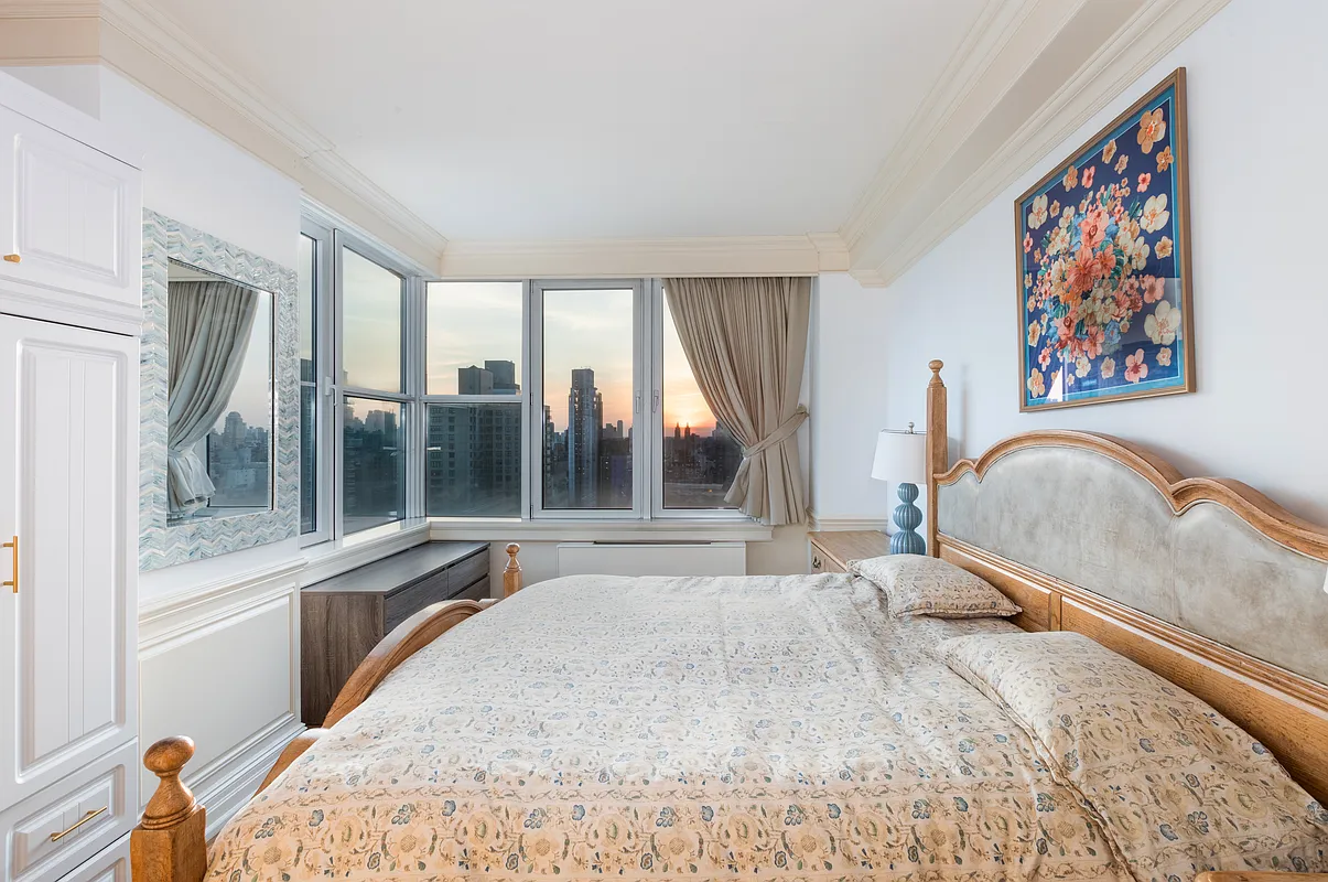 404 East 76th Street, Unit 30C Manhattan, NY 10021 - Photo 14 of 24 a bedroom with furniture and a large window