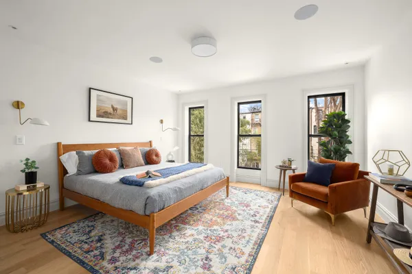 a bedroom with a bed couch and a window