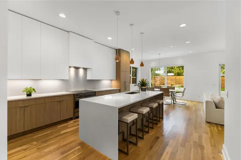 a kitchen with stainless steel appliances granite countertop a sink and a stove top oven