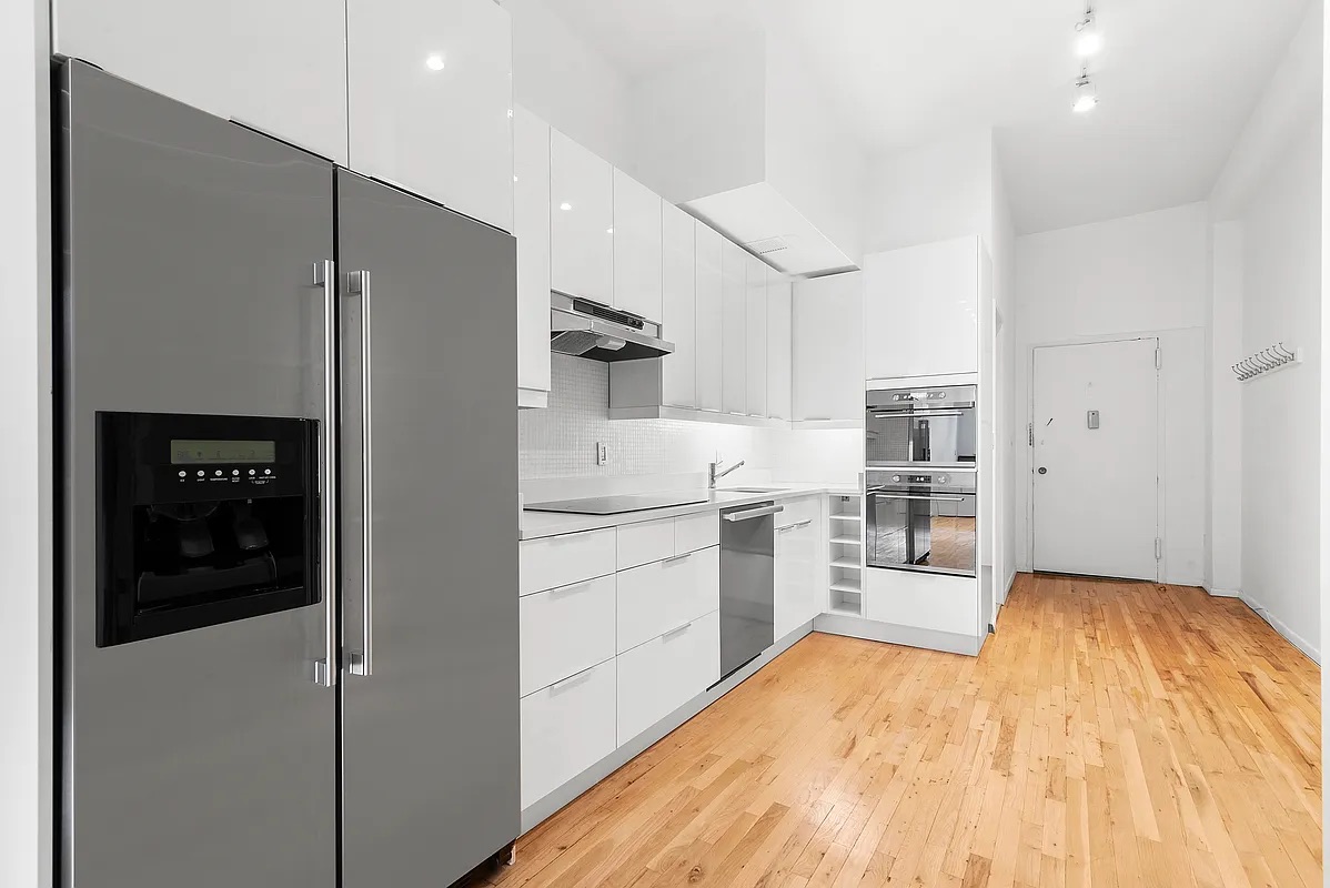 23 Waverly Place, Unit 6M Manhattan, NY 10003 - Photo 2 of 22 a kitchen with a refrigerator and a sink