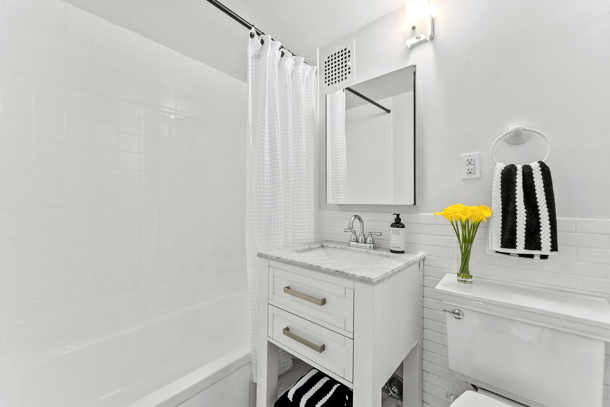 207 East 21st Street, Unit 6E Manhattan, NY 10010 - Photo 9 of 12 a bathroom with a sink a toilet and shower