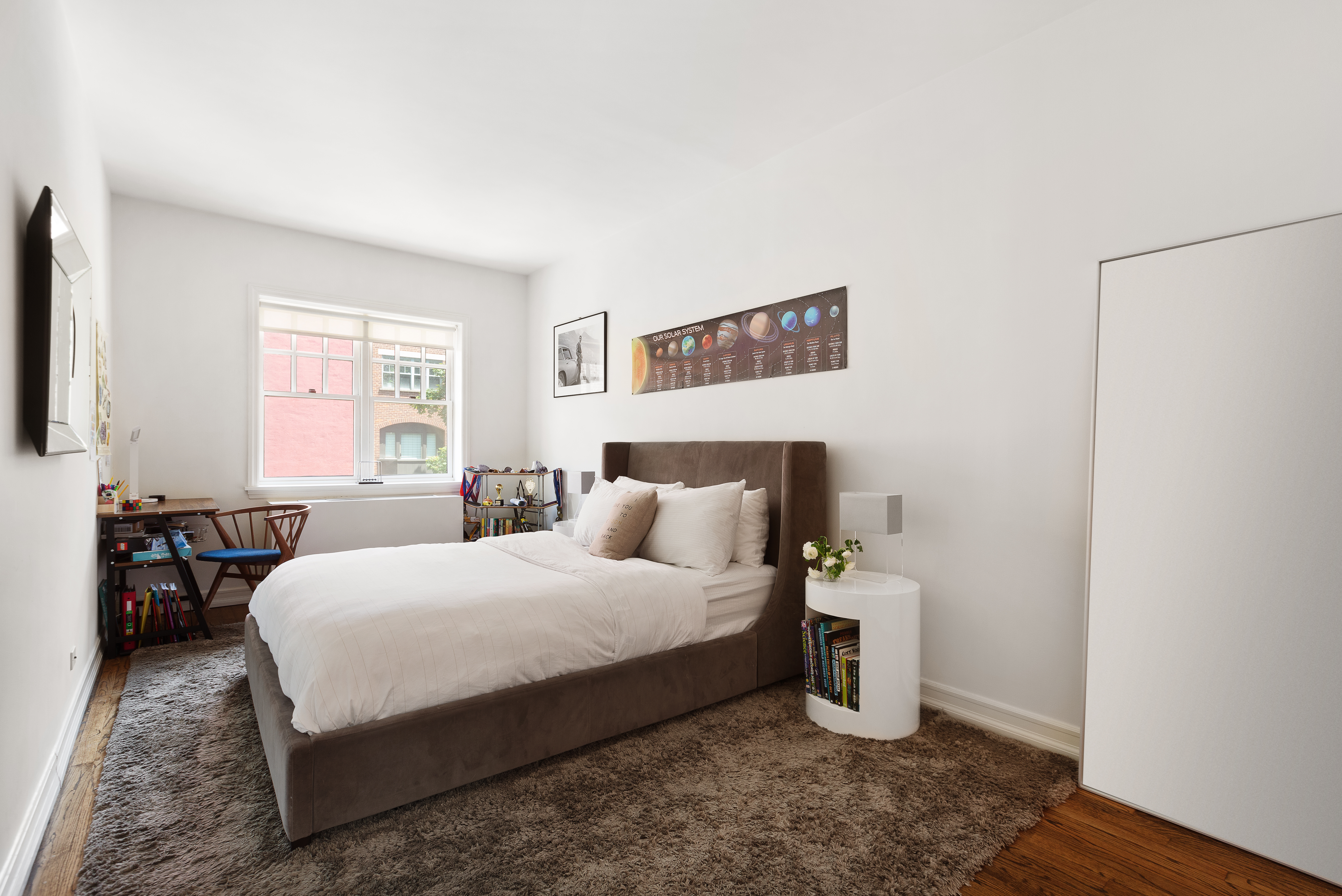 687 Greenwich Street, Unit TH7 Manhattan, NY 10014 - Photo 14 of 23 a bedroom with a bed and wooden floor