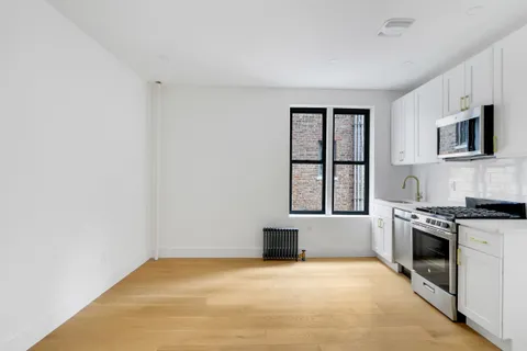 a view of kitchen with stainless steel appliances granite countertop a stove top oven