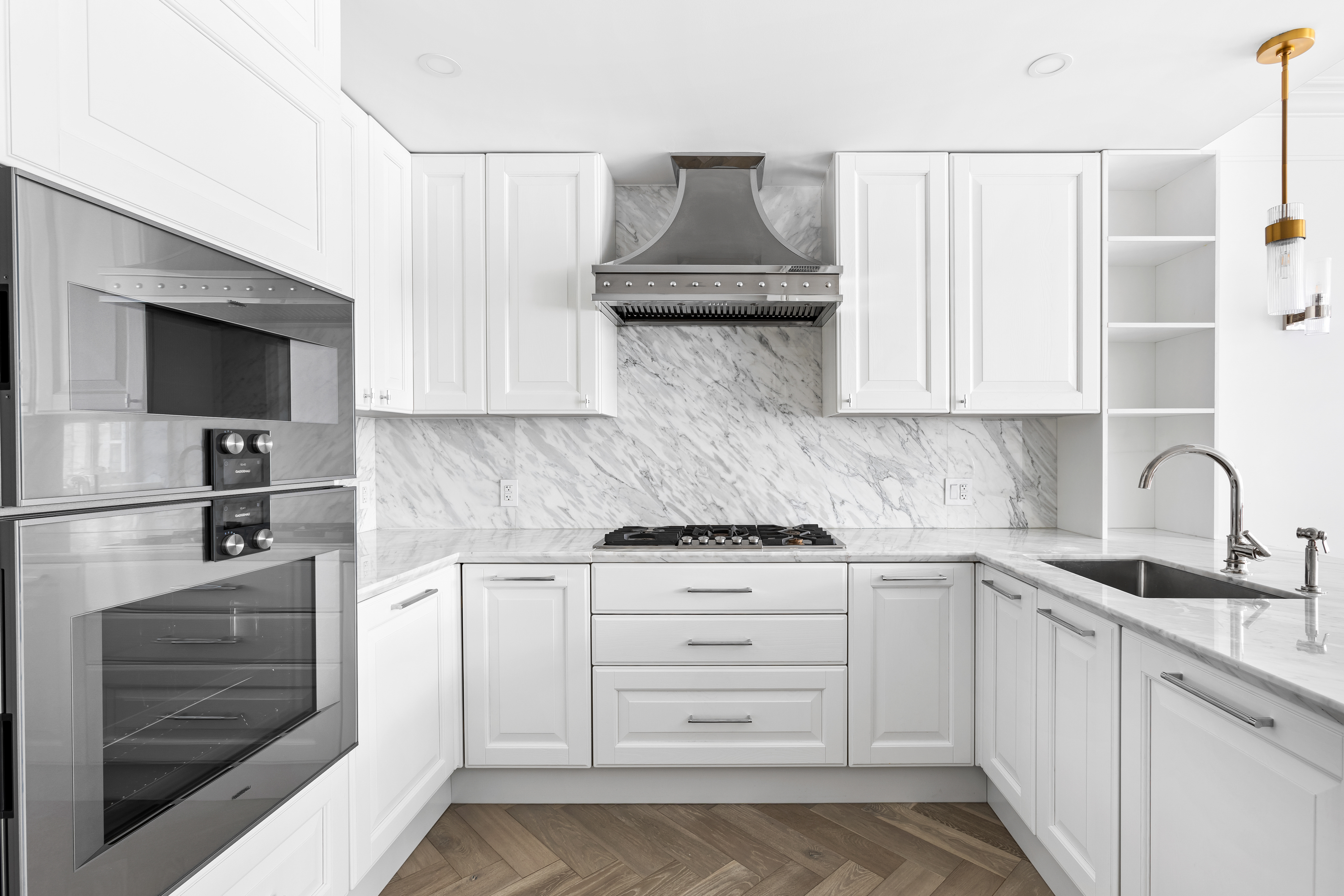 126 East 86th Street, Unit 5B Manhattan, NY 10028 - Photo 4 of 22 a kitchen with stainless steel appliances granite countertop a sink and a stove top oven with white cabinets