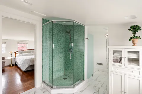 a en suite bathroom with a shower a sink and a mirror