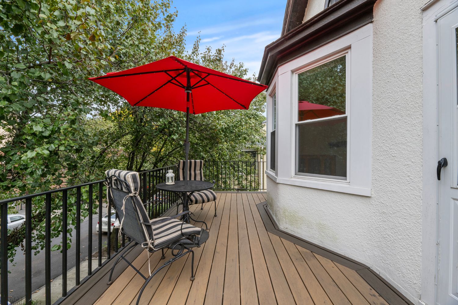 a view of balcony with furniture and umbrella