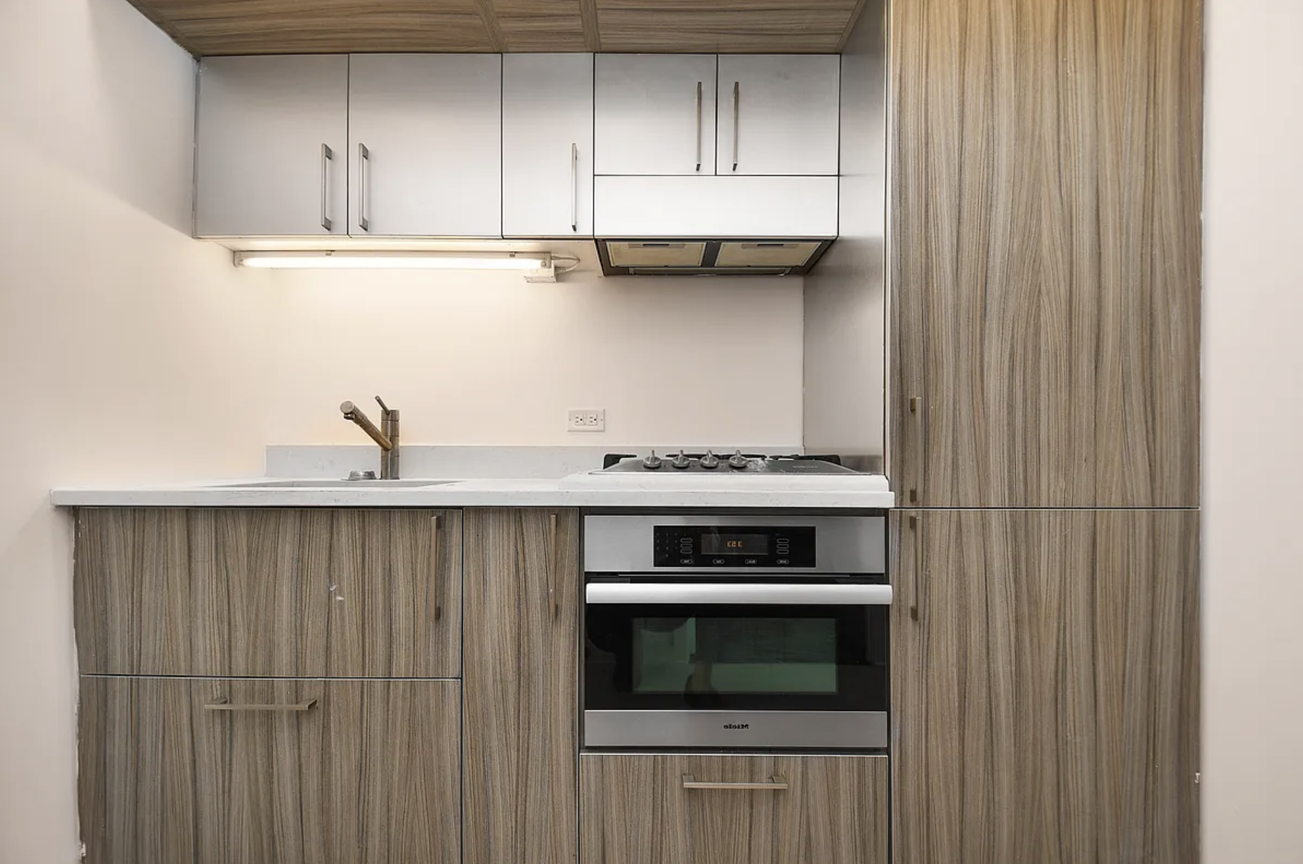250 Bedford Avenue, Unit 129405 Brooklyn, NY 11249 - Photo 2 of 8 a kitchen with stainless steel appliances a stove and a microwave