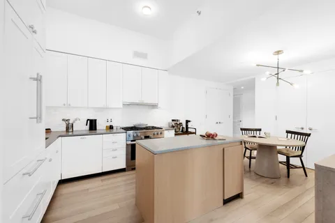 a kitchen with a sink a stove and cabinets