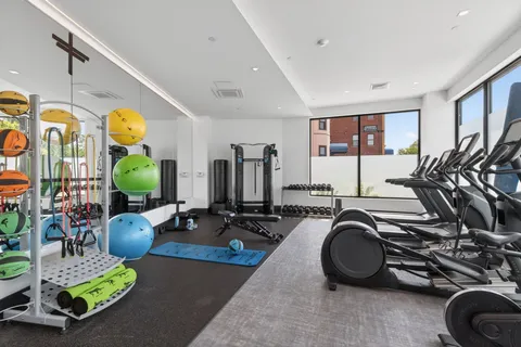 a room with gym equipment and windows