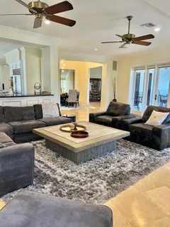 a living room with furniture and a chandelier