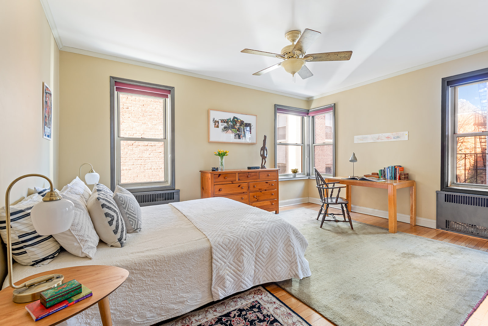 9281 Shore Road, Unit 207 Brooklyn, NY 11209 - Photo 6 of 11 a bedroom with a bed and a chandelier