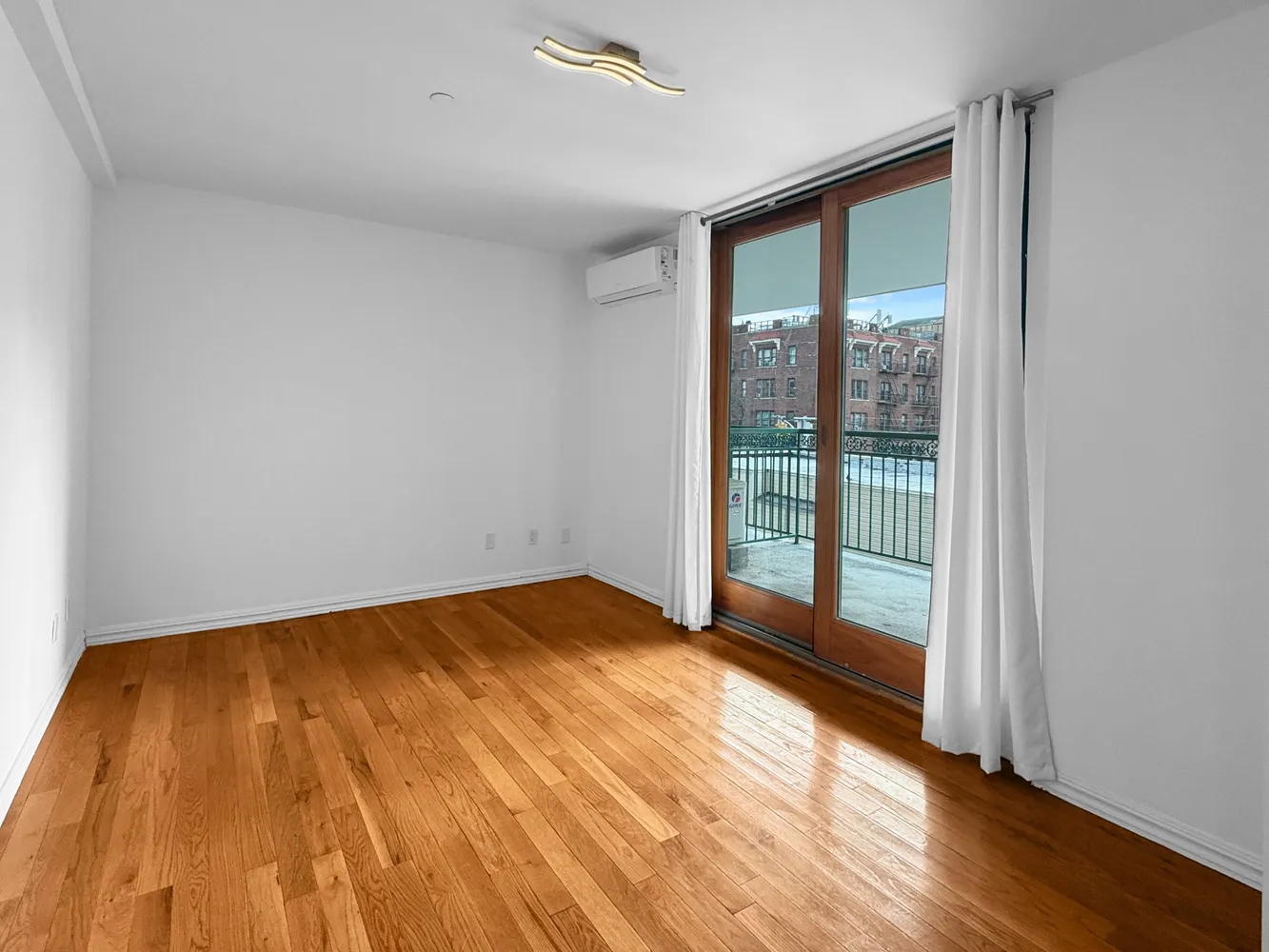 a view of an empty room and wooden floor