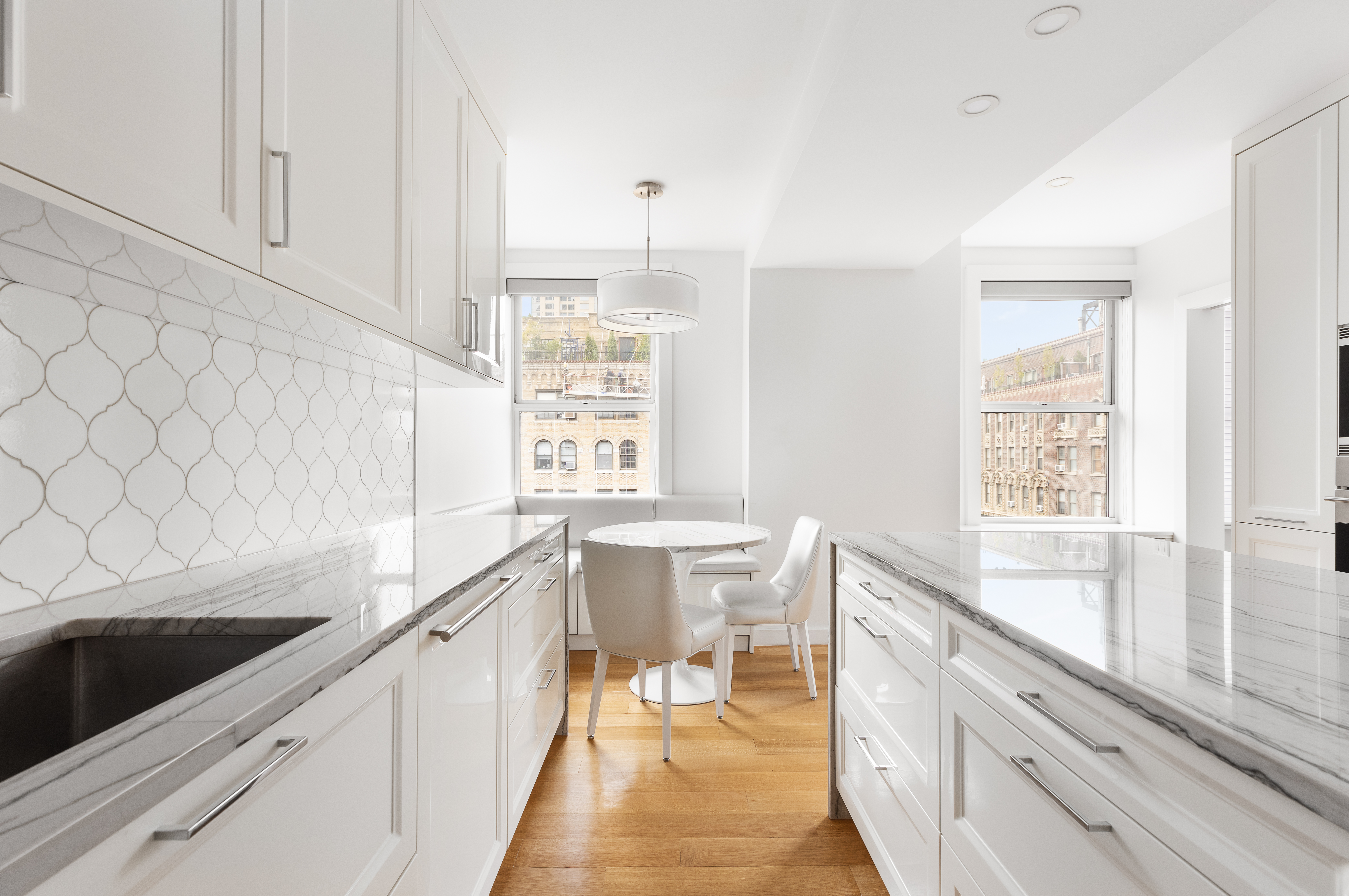 240 West End Avenue, Unit PH Manhattan, NY 10023 - Photo 6 of 25 a view of a kitchen with a sink and wooden floor