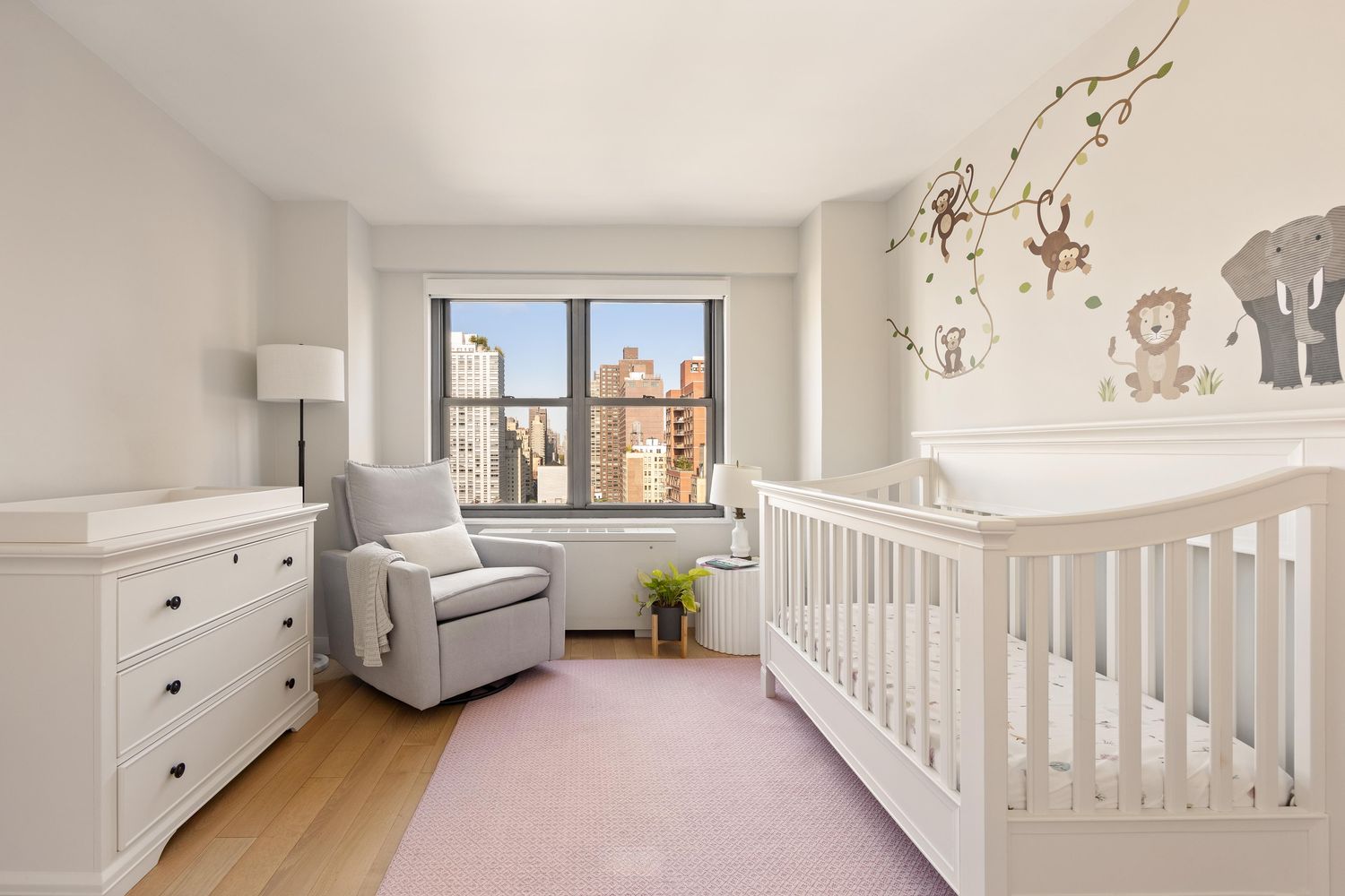 a bedroom with furniture and a large window