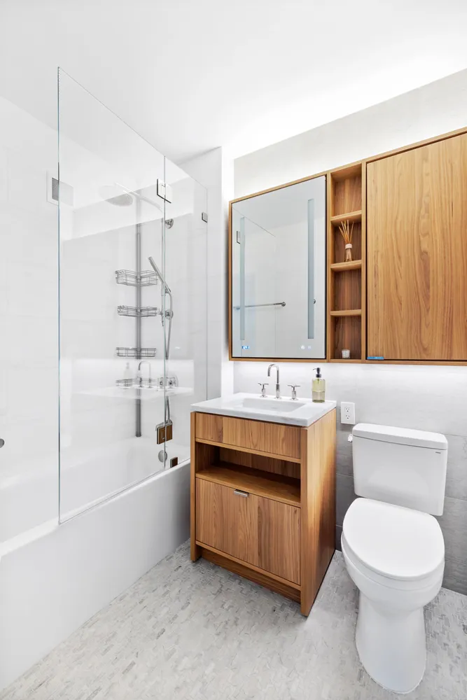 a bathroom with a sink a toilet and shower