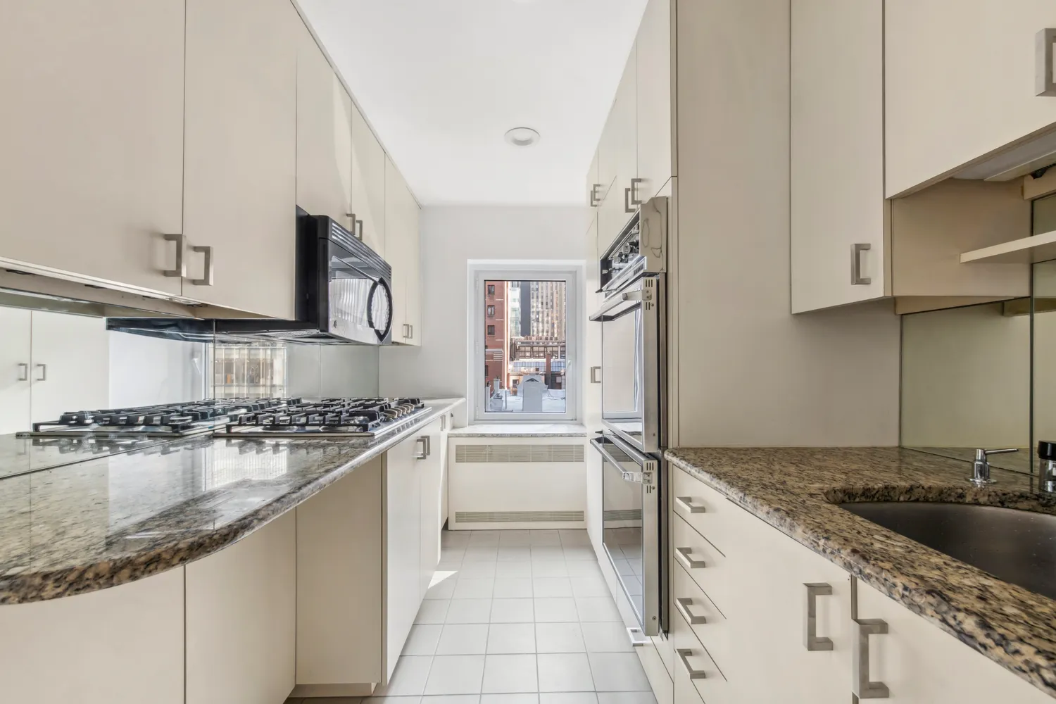 a kitchen with stainless steel appliances granite countertop a sink stove and cabinets